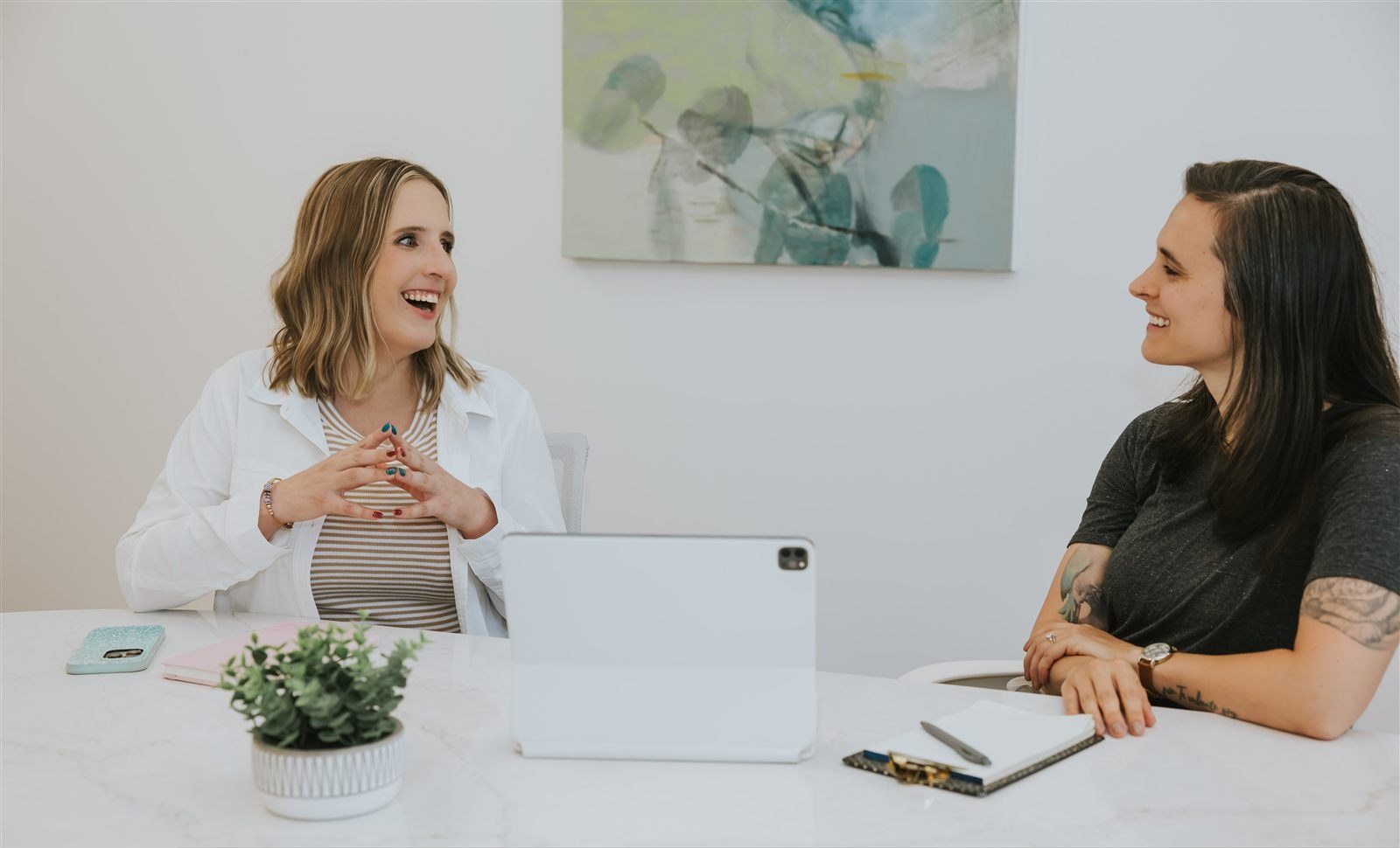 Maren working with a client at a desk