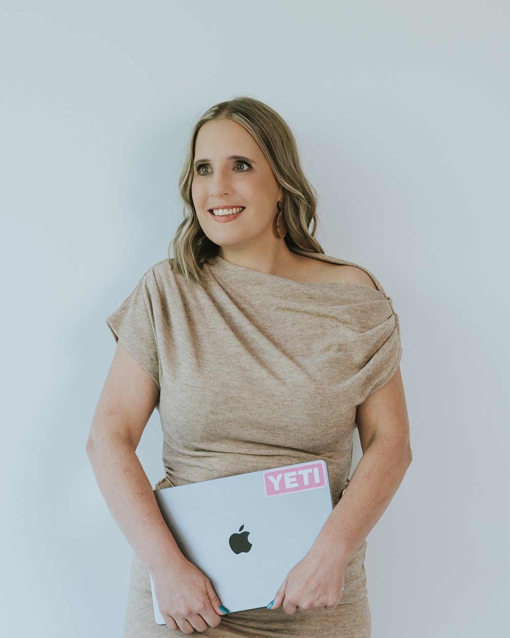 Maren Londahl-Smidt standing with a laptop, smiling